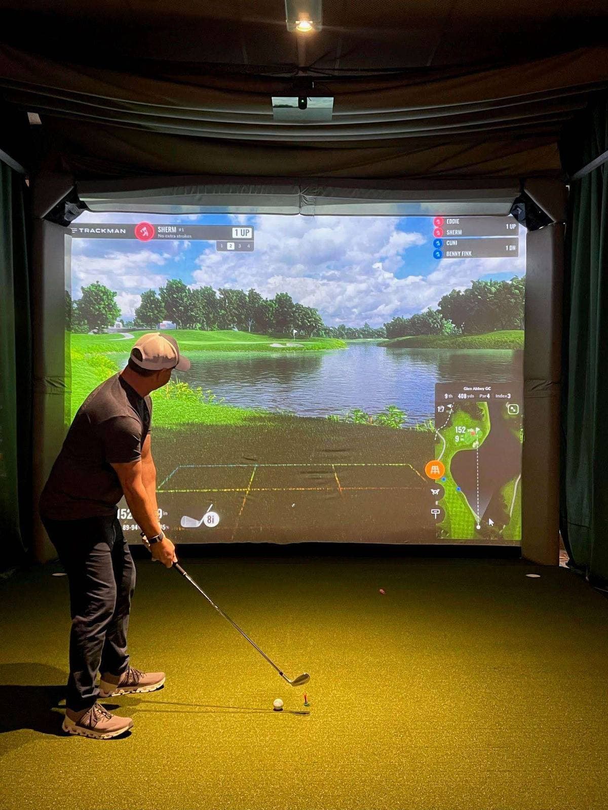 Bar area with HD TVs and TrackMan displays at Gonzo's