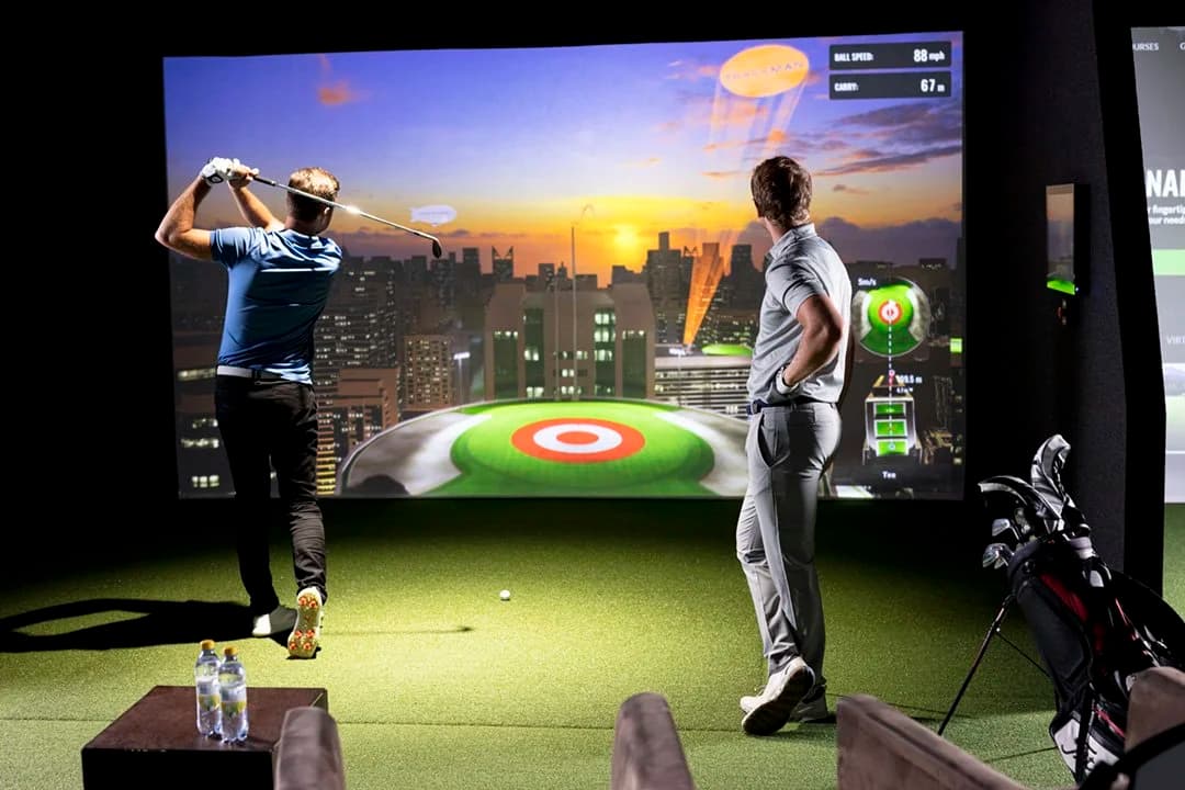 Players competing in a Bullseye game on the TrackMan simulator